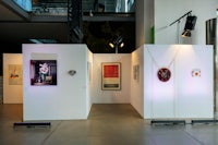 a room with a lot of art on display